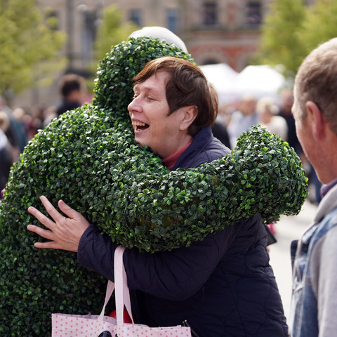 The Hedge Men giving hugs at a food festival in Bishop Auckland.