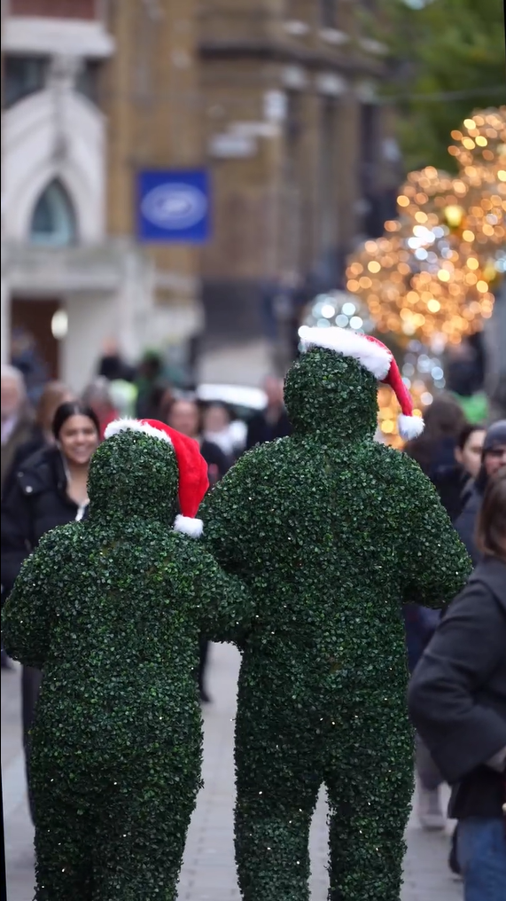 The Christmas Hedge Men performing at a London Christmas Market event.