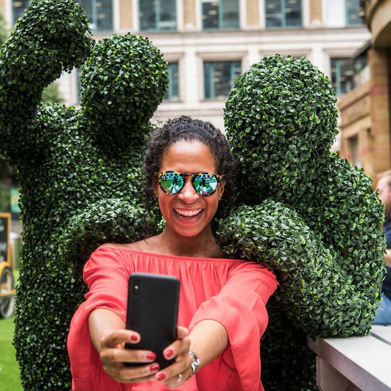 The Human Hedges taking a selfie at a green themed outdoor event in London.