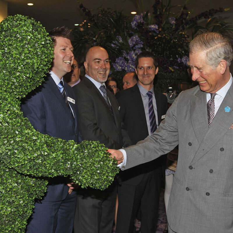 A Hedge Man meeting King Charles at an exhibition in London.