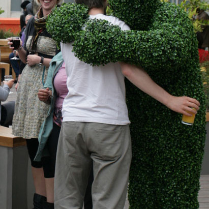A Hedge Man giving a hug at an event in London.